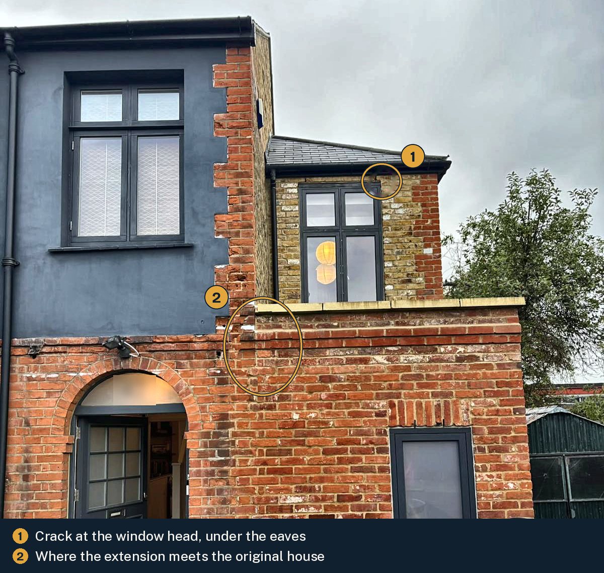 Outside of a house with a first-floor extension, marked to show cracking at the corner of the window head under the eaves and the joint where the extension brickwork meets the original house